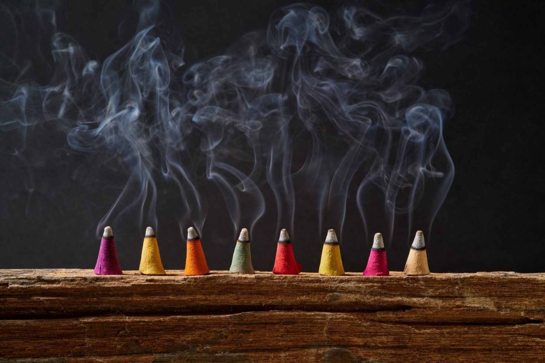 Colorful incense cones with smoke